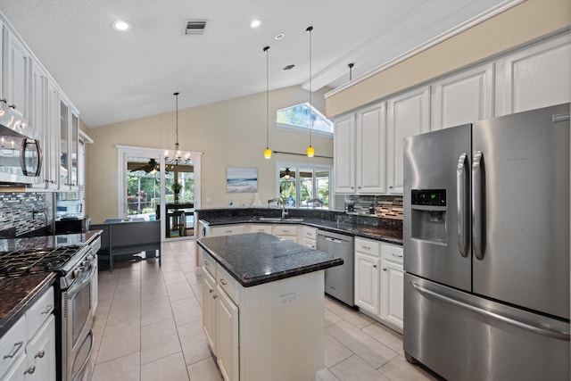 kitchen with appliances with stainless steel finishes, tasteful backsplash, white cabinetry, recessed lighting, and high vaulted ceiling