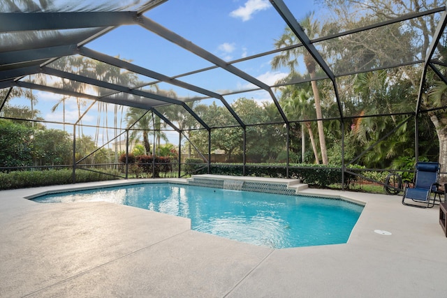 outdoor pool with a lanai and a patio area