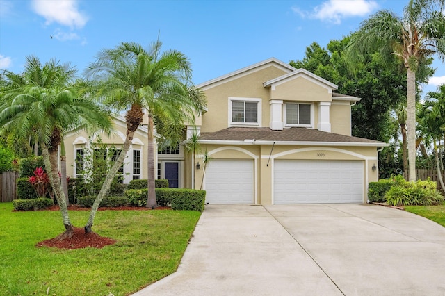 view of front of house featuring driveway, stucco siding, and a garage
