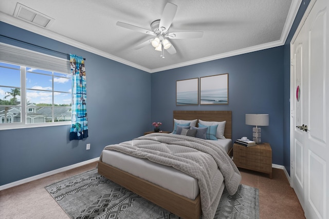 bedroom featuring carpet, baseboards, ceiling fan, ornamental molding, and a textured ceiling