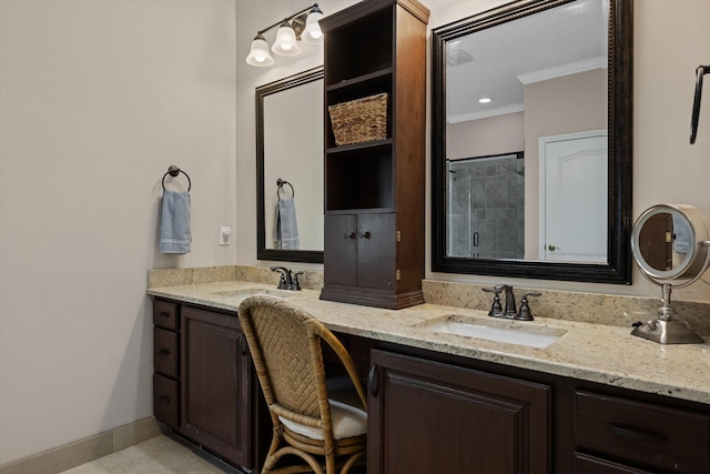 full bathroom with ornamental molding, double vanity, tile patterned floors, a tile shower, and baseboards