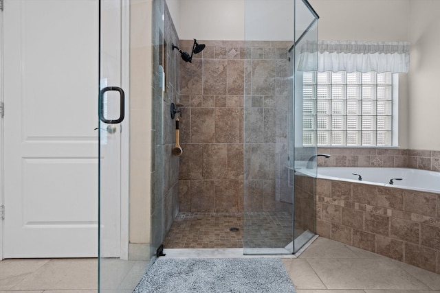 full bath with tile patterned floors, a shower stall, and a bath