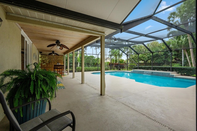 outdoor pool with a patio, ceiling fan, and a lanai