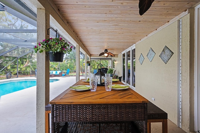 sunroom with a ceiling fan, outdoor dining area, and healthy amount of natural light