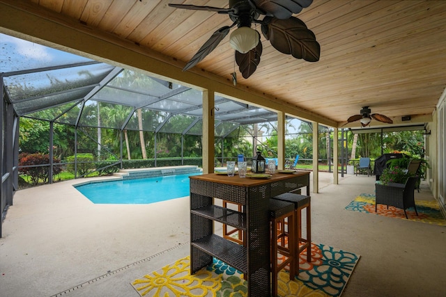 outdoor pool with a ceiling fan, a patio, and a lanai