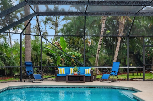 outdoor pool featuring a patio, an outdoor living space, and glass enclosure