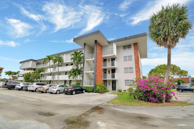 view of property featuring uncovered parking