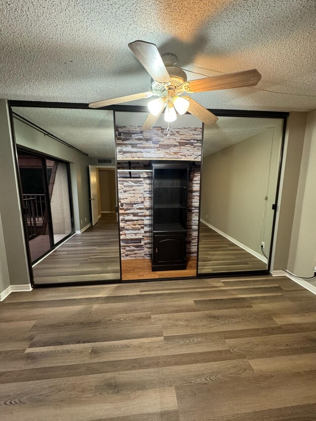 1458 N Lawnwood Cir Unit 23A, Fort Pierce, FL 34950 - unfurnished living room featuring a textured ceiling, baseboards, wood finished floors, ceiling fan, and stairs