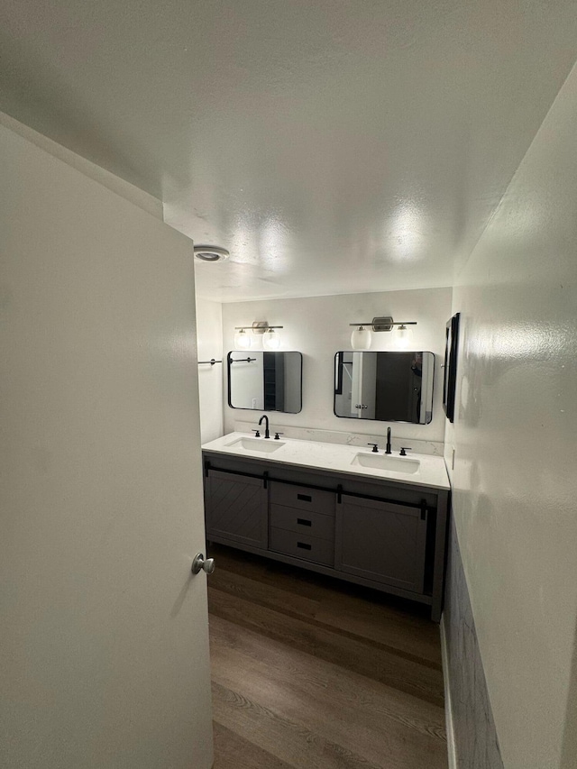 1458 N Lawnwood Cir Unit 23A, Fort Pierce, FL 34950 - full bathroom featuring wood finished floors and double vanity