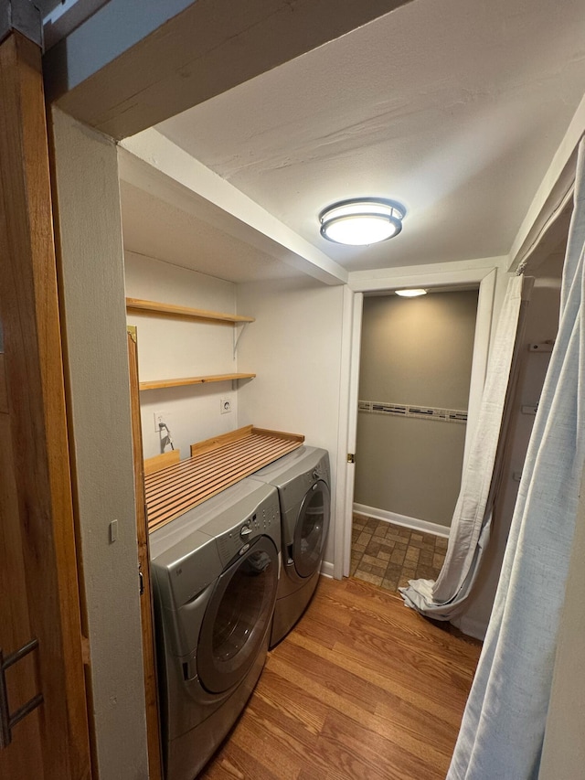 1458 N Lawnwood Cir Unit 23A, Fort Pierce, FL 34950 - washroom with washing machine and clothes dryer, wood finished floors, and baseboards