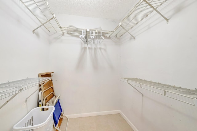 spacious closet with tile patterned floors