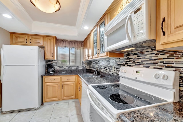 kitchen with a sink, white appliances, a raised ceiling, and crown molding