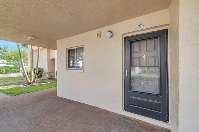 property entrance featuring stucco siding