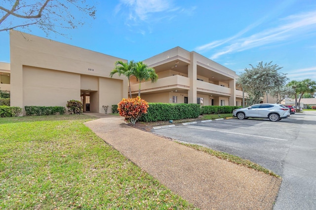 view of property featuring uncovered parking