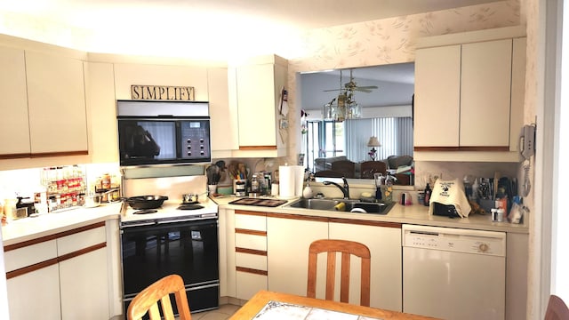 kitchen with white dishwasher, light countertops, black microwave, a sink, and range with electric stovetop