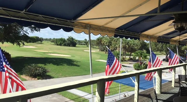 exterior space with a yard and golf course view