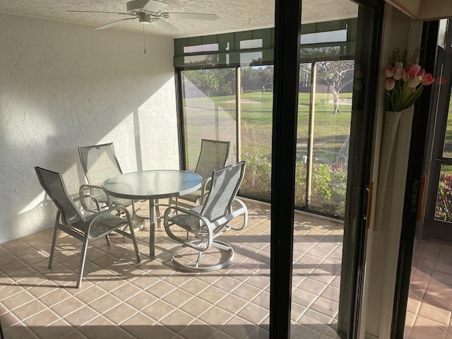 sunroom / solarium with a ceiling fan