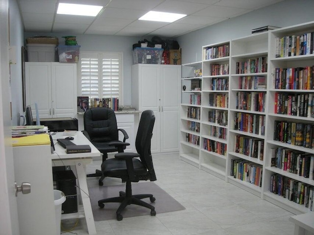 office space with a paneled ceiling