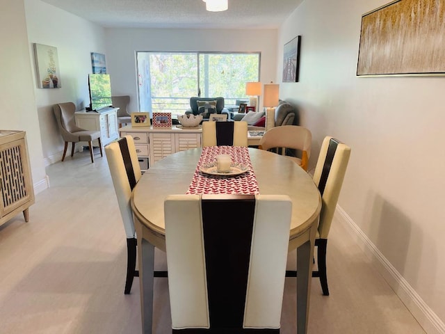 dining space featuring baseboards