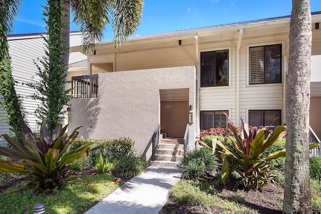 entrance to property featuring stucco siding