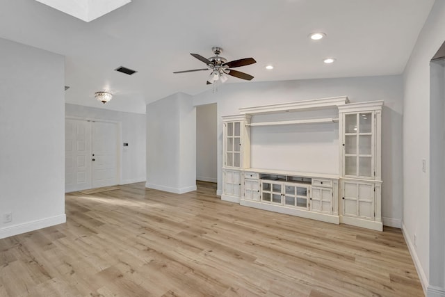 unfurnished living room featuring light wood finished floors, baseboards, and a ceiling fan