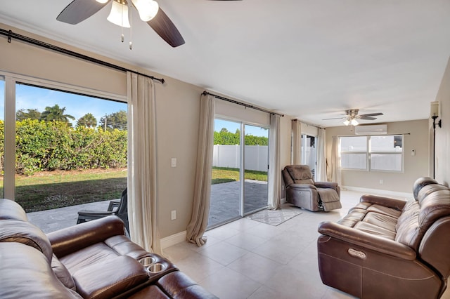 living room featuring a wall mounted AC, a ceiling fan, and baseboards