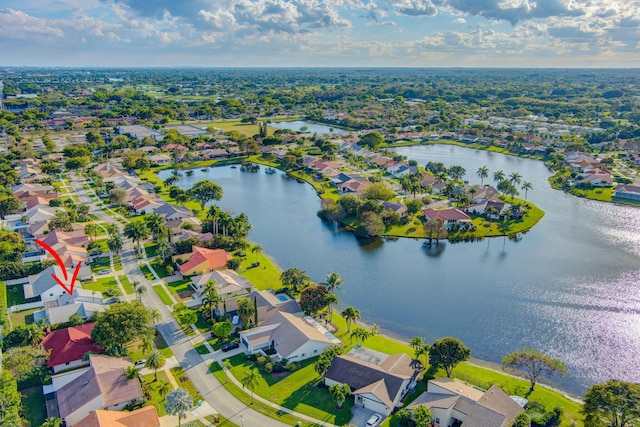 birds eye view of property with a water view and a residential view