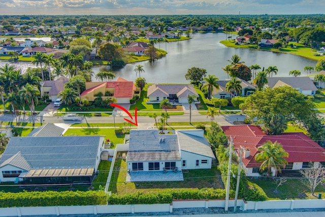 birds eye view of property with a water view and a residential view