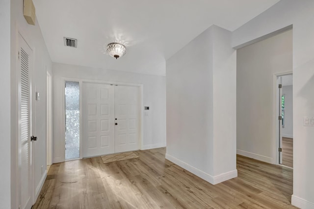 foyer entrance featuring light wood-style flooring, plenty of natural light, and visible vents