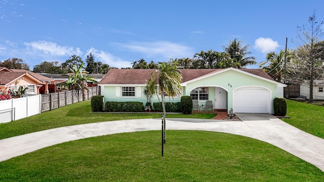 ranch-style house featuring driveway, an attached garage, fence, a front lawn, and stucco siding