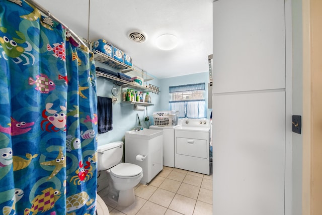 bathroom with visible vents, washer and clothes dryer, a shower with shower curtain, toilet, and tile patterned flooring