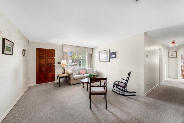 carpeted living room with baseboards