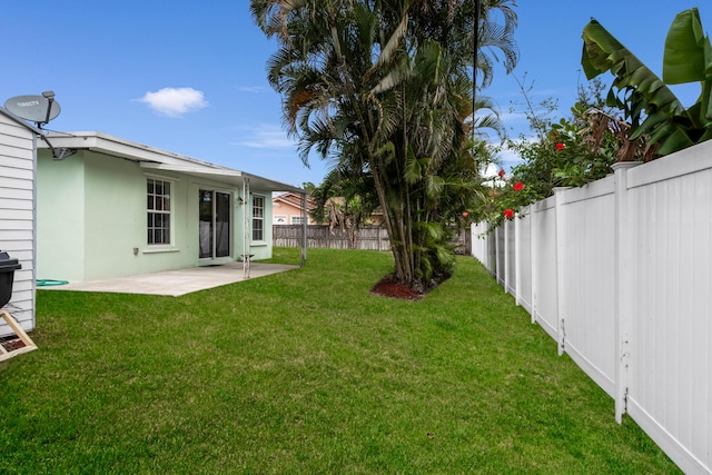 view of yard with a patio area and a fenced backyard