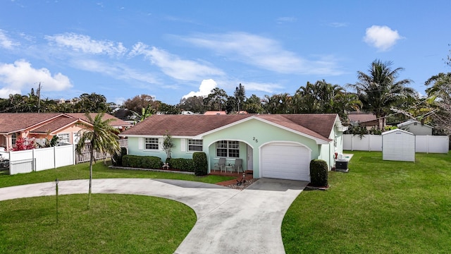 view of front of property with a garage, fence, concrete driveway, stucco siding, and a front yard