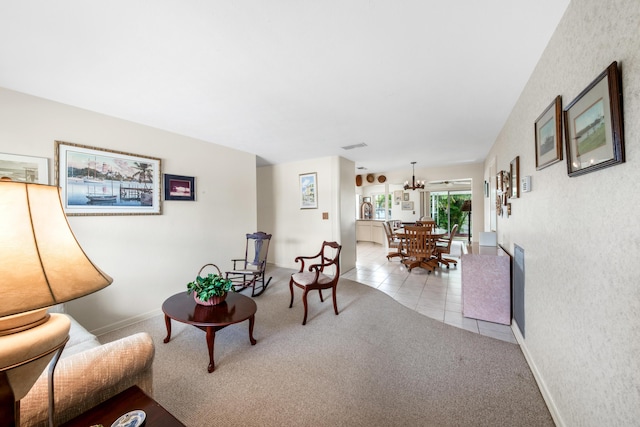 living room with carpet, baseboards, and tile patterned floors