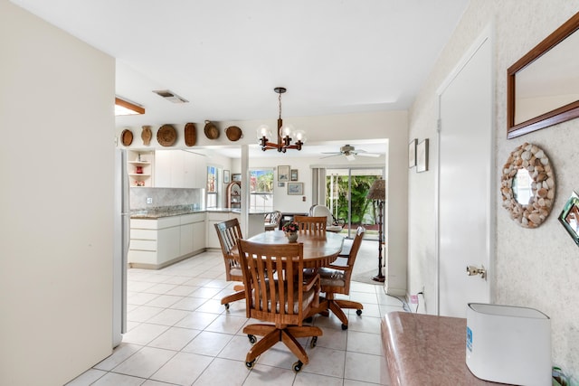 dining area with a chandelier, light tile patterned floors, and visible vents