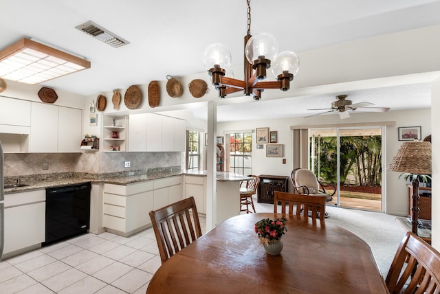 dining area featuring ceiling fan with notable chandelier, visible vents, and light tile patterned floors