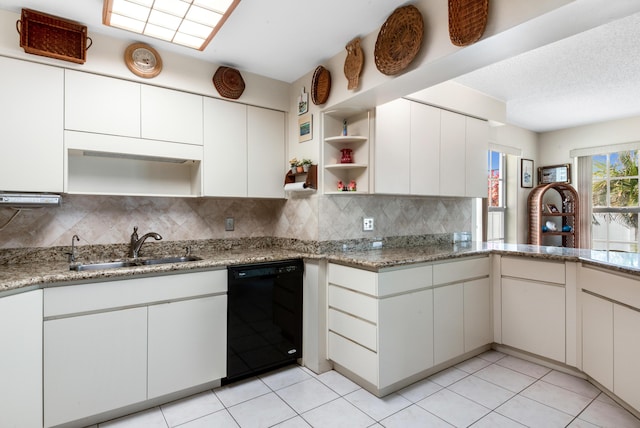 kitchen featuring black dishwasher, light tile patterned floors, open shelves, decorative backsplash, and a sink