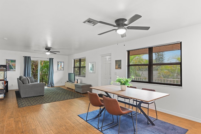 dining room featuring ceiling fan, wood finished floors, and baseboards