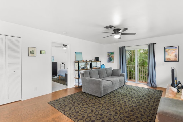 living area featuring ceiling fan, wood finished floors, and visible vents