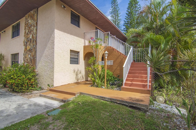 entrance to property featuring stucco siding