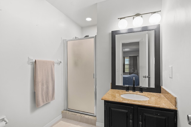 bathroom with a shower stall and vanity