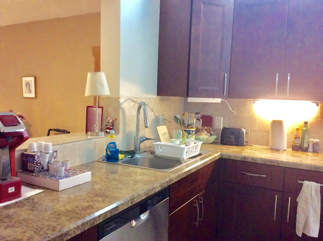 kitchen with a sink, decorative backsplash, and dishwasher