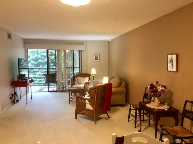 living area featuring light carpet and visible vents