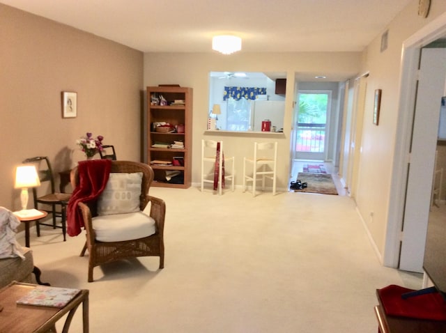 living area featuring carpet flooring and visible vents