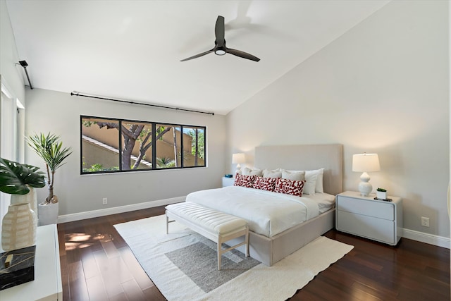 bedroom with a ceiling fan, lofted ceiling, wood finished floors, and baseboards