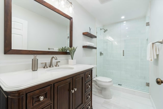 bathroom featuring vanity, toilet, and a stall shower