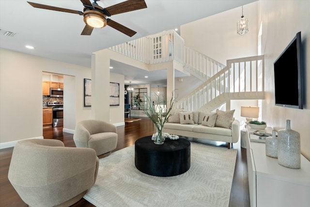 living room featuring visible vents, baseboards, stairs, recessed lighting, and dark wood-style flooring