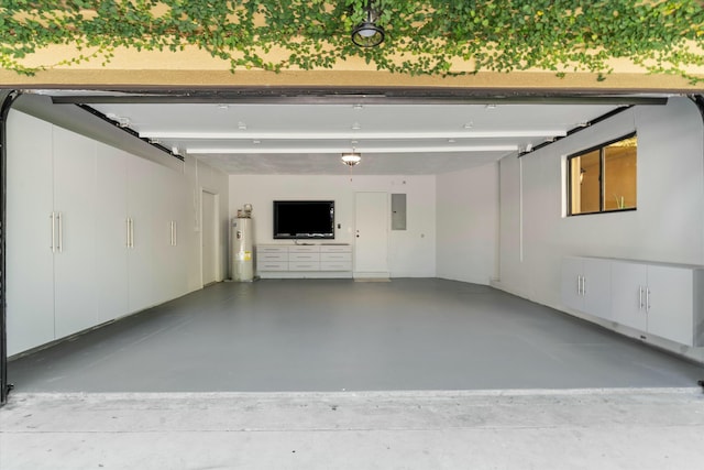 garage featuring electric panel and water heater