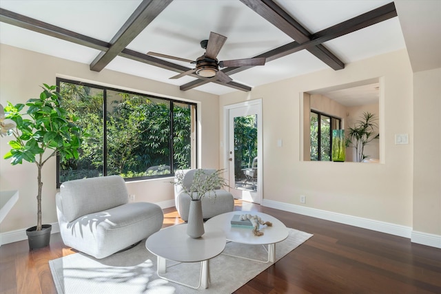 sitting room with baseboards, a healthy amount of sunlight, and wood finished floors